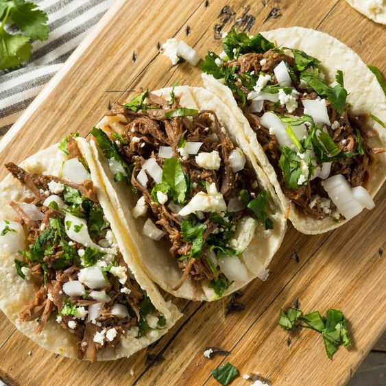 Pulled Pork Tacos with Cilantro and White Onions.
