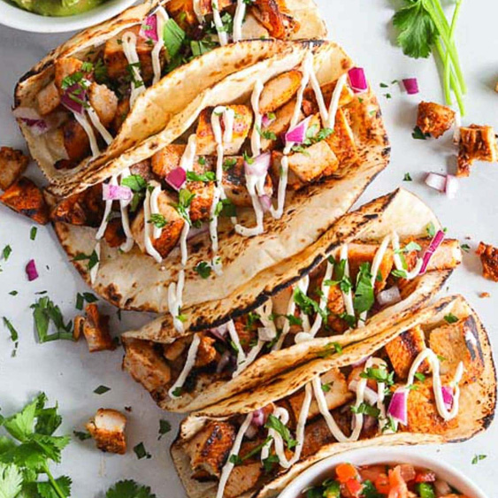 Grilled Chicken Tacos with Fancy Crema and Red Onions.